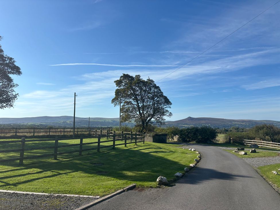A landscape view with a tree and fence at Y Cwtch in Newport