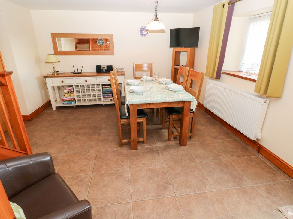 A dining room with table and chairs at Bwthyn Trecoed St. Clears near Carmarthen
