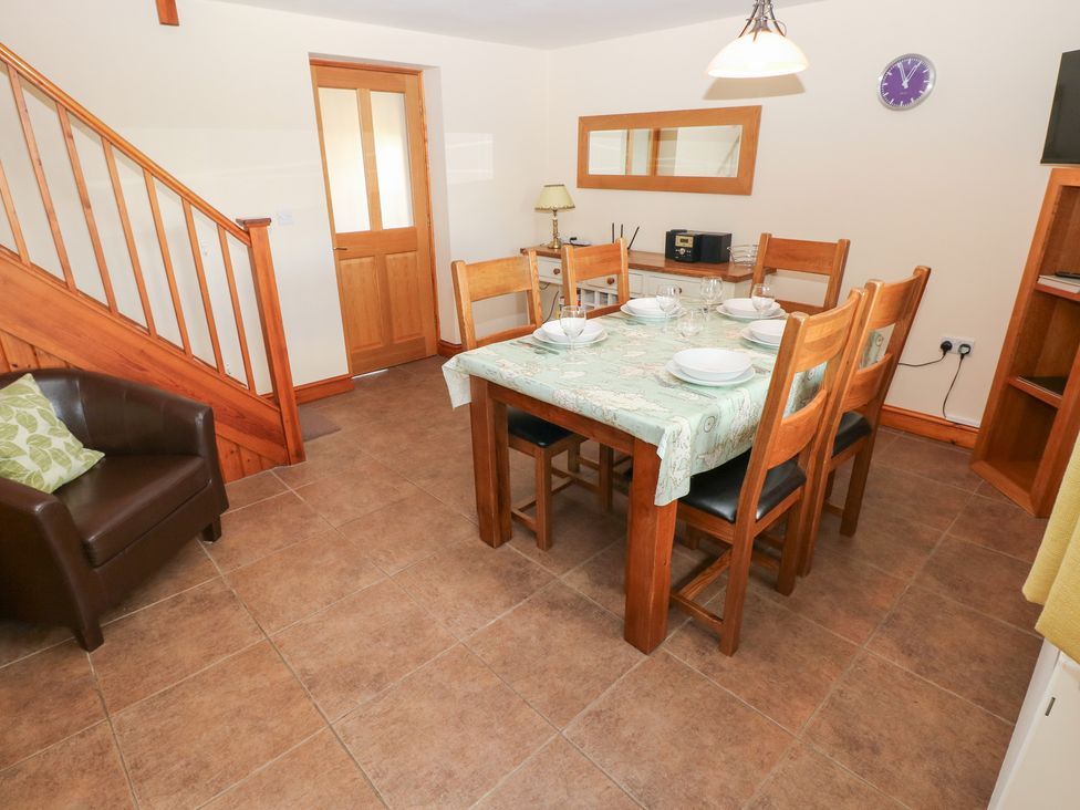 A dining room with a table and chairs at Bwthyn Trecoed St. Clears near Carmarthen