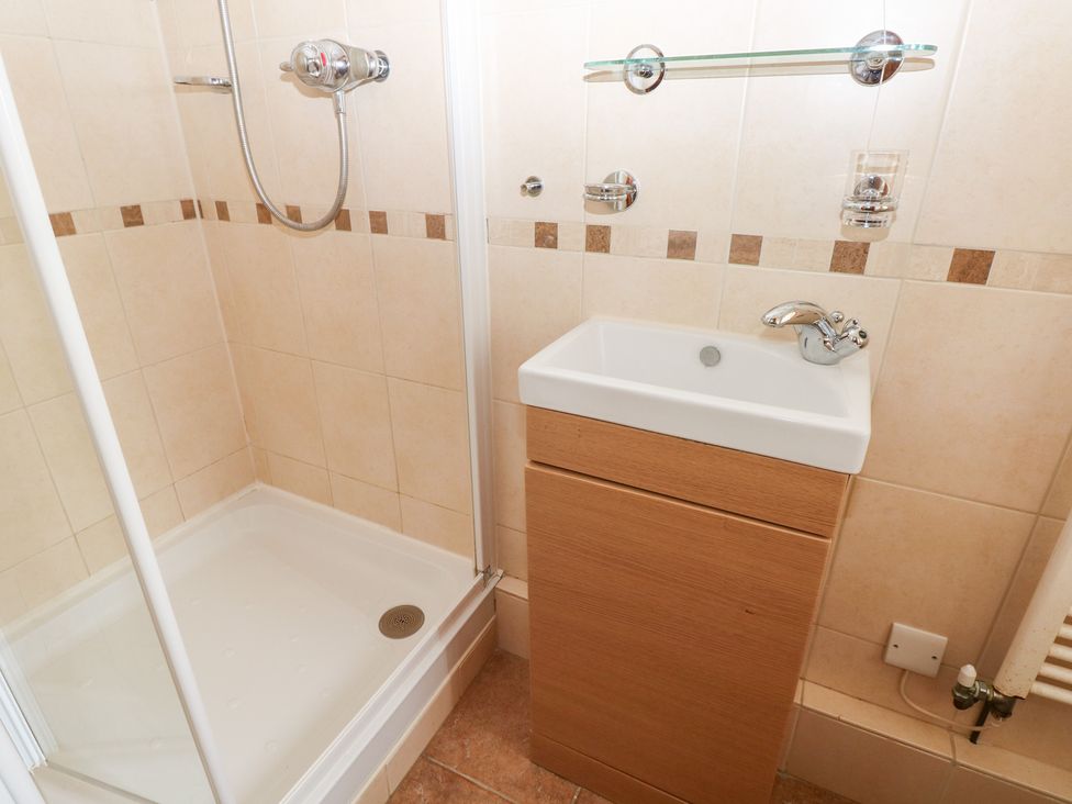 A bathroom with a shower and sink at Bwthyn Trecoed in St. Clears near Carmarthen
