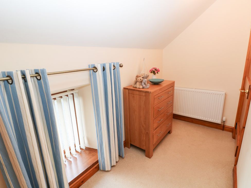 A bedroom with a chest of drawers and teddy bear at Bwthyn Trecoed St. Clears near Carmarthen