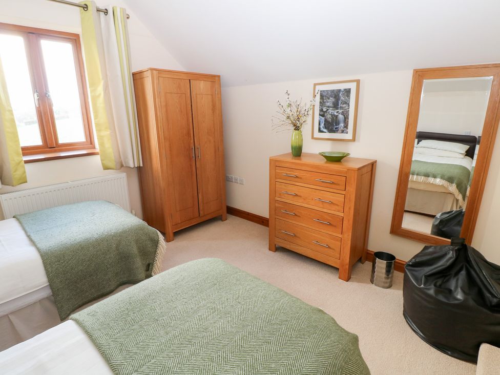 A bedroom with two beds and furniture at Bwthyn Trecoed St. Clears near Carmarthen