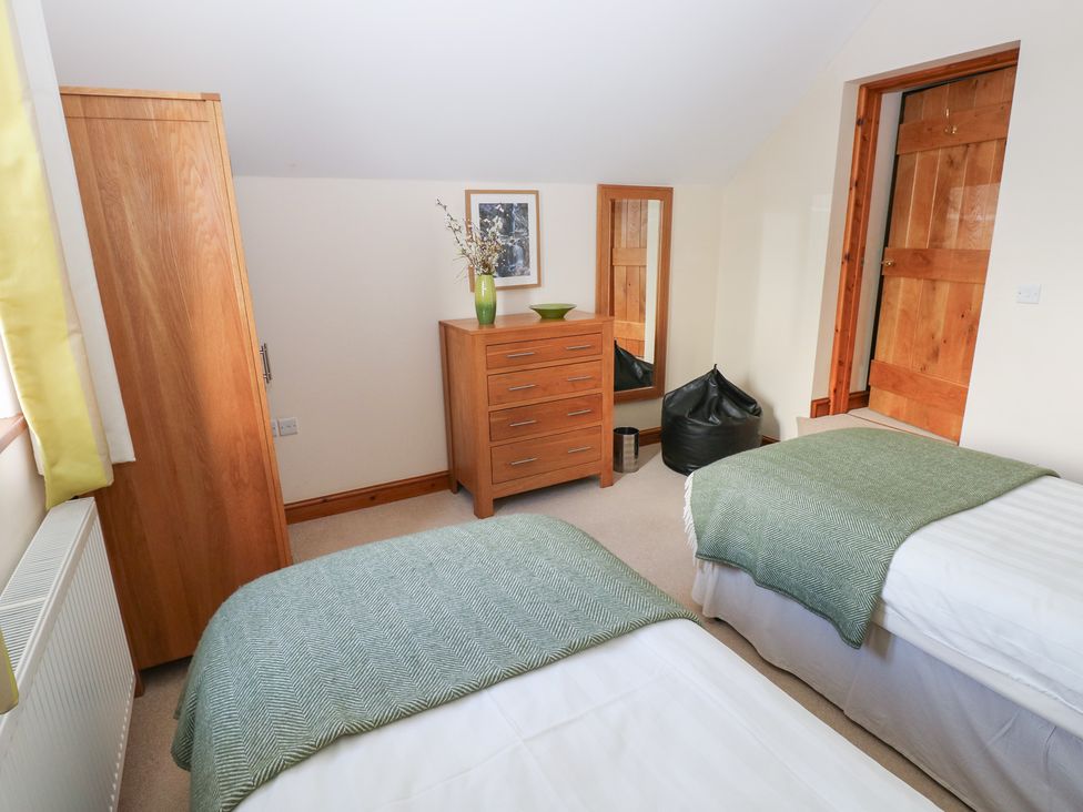 A bedroom with two beds and furniture at Bwthyn Trecoed St. Clears near Carmarthen