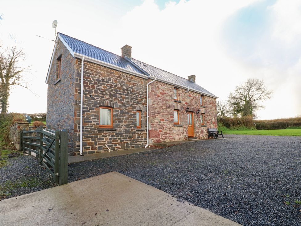 A house with stone walls and a gate at Bwthyn Trecoed St. Clears near Carmarthen
