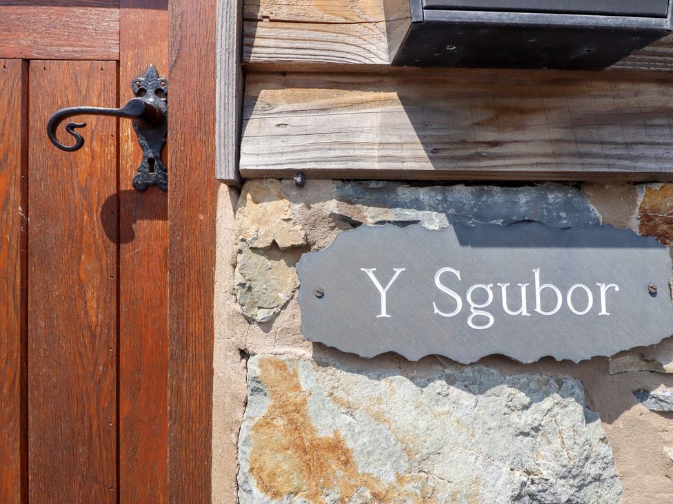 A door with a sign that says Y Sgubor at Ysgubor Pwlliago, Pennant Valley near Llangynog