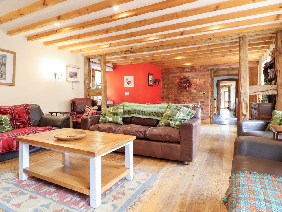 A living room with sofas and a coffee table at Ysgubor Pwlliago, Pennant Valley near Llangynog