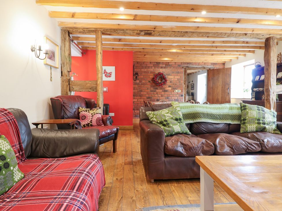 A living room with sofas and a coffee table at Ysgubor Pwlliago Pennant Valley near Llangynog