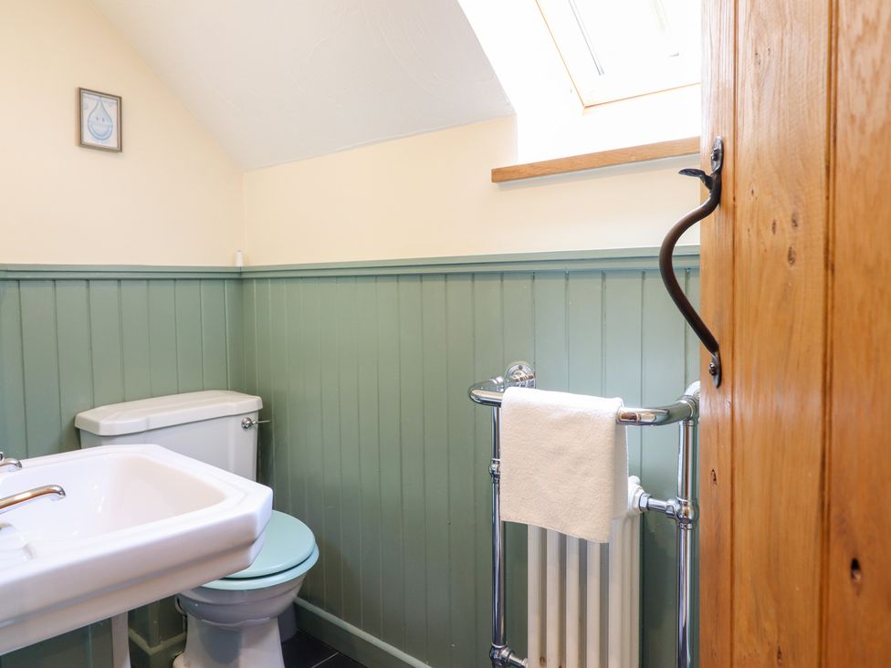 A bathroom with a toilet and sink at Ysgubor Pwlliago near Pennant Valley Llangynog