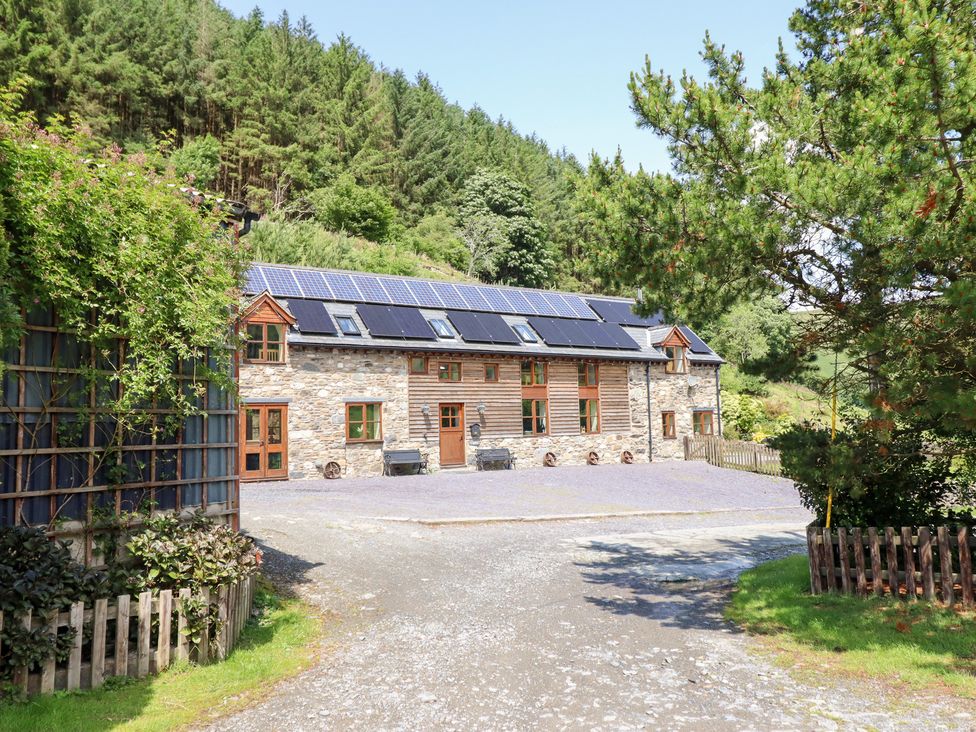 A house with solar panels and a driveway at Ysgubor Pwlliago in Pennant Valley near Llangynog