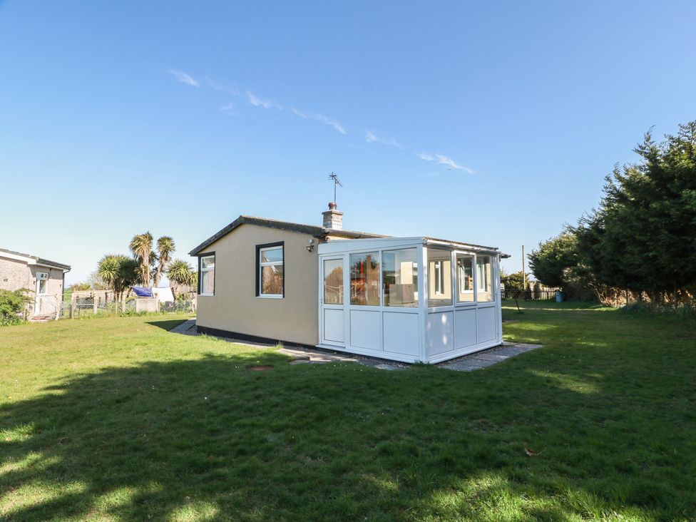 A house with a conservatory in a garden at Kouloura Southerness