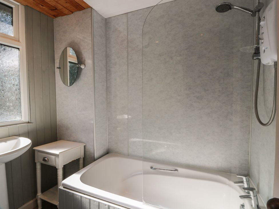 A bathroom with a bathtub and shower at Kouloura in Southerness