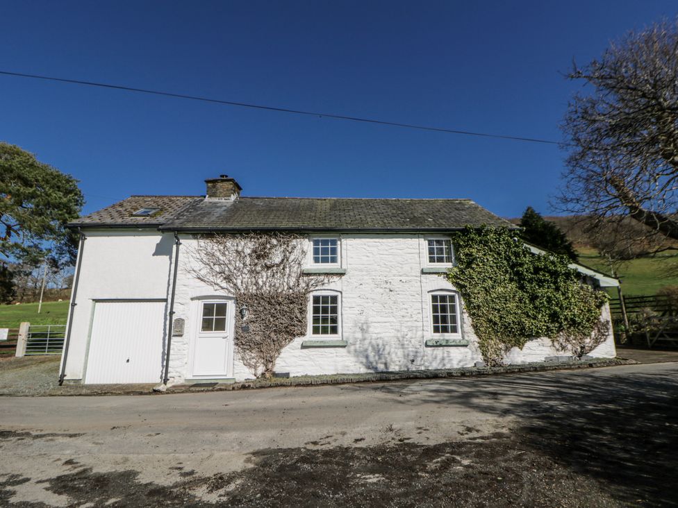 An exterior view of a house with ivy on the wall at Penlone Cottage Rhayader