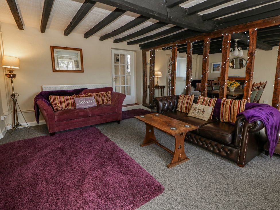 A living room with sofas and a coffee table at Penlone Cottage in Rhayader