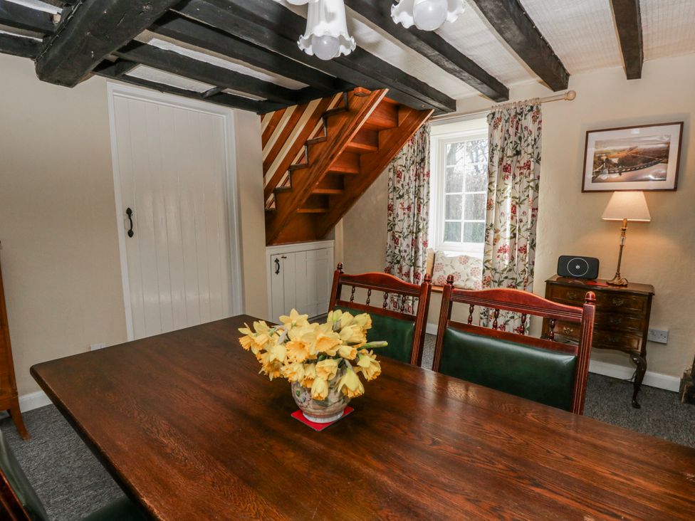 A dining room with a table and chairs at Penlone Cottage in Rhayader