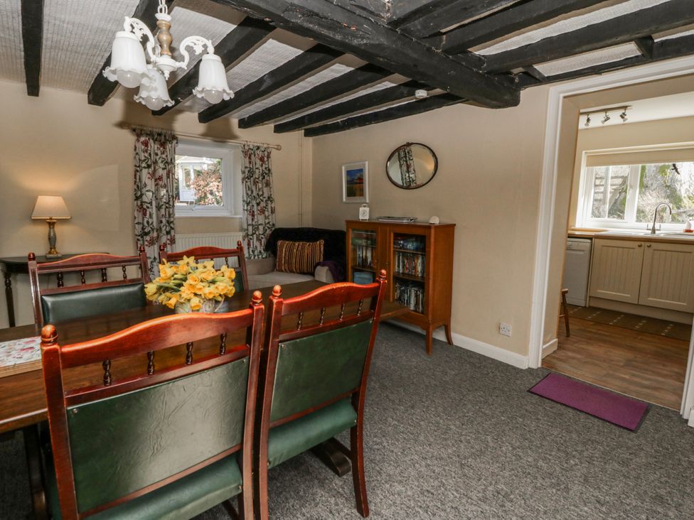 A dining room with a table and chairs at Penlone Cottage Rhayader