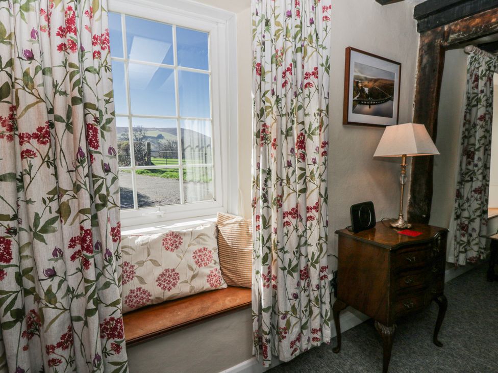 A sitting room with a window and seat at Penlone Cottage Rhayader