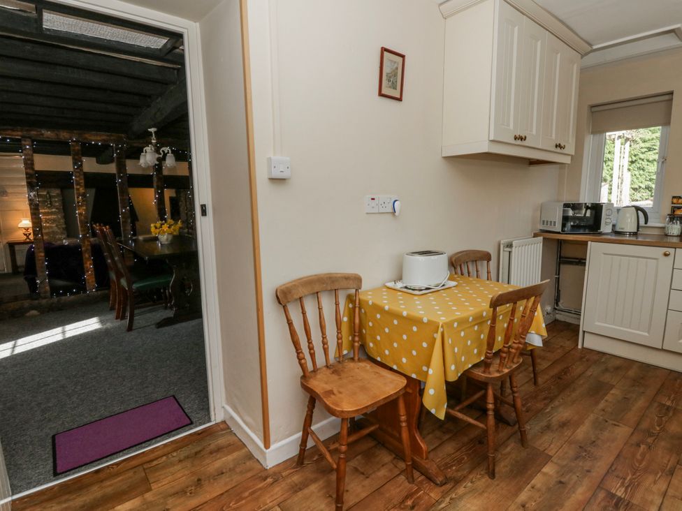 A kitchen with a table and chairs at Penlone Cottage in Rhayader