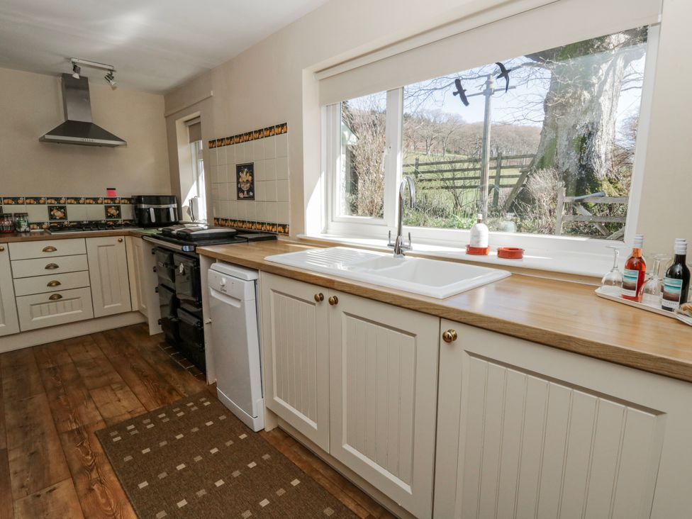 A kitchen with a sink and oven at Penlone Cottage in Rhayader