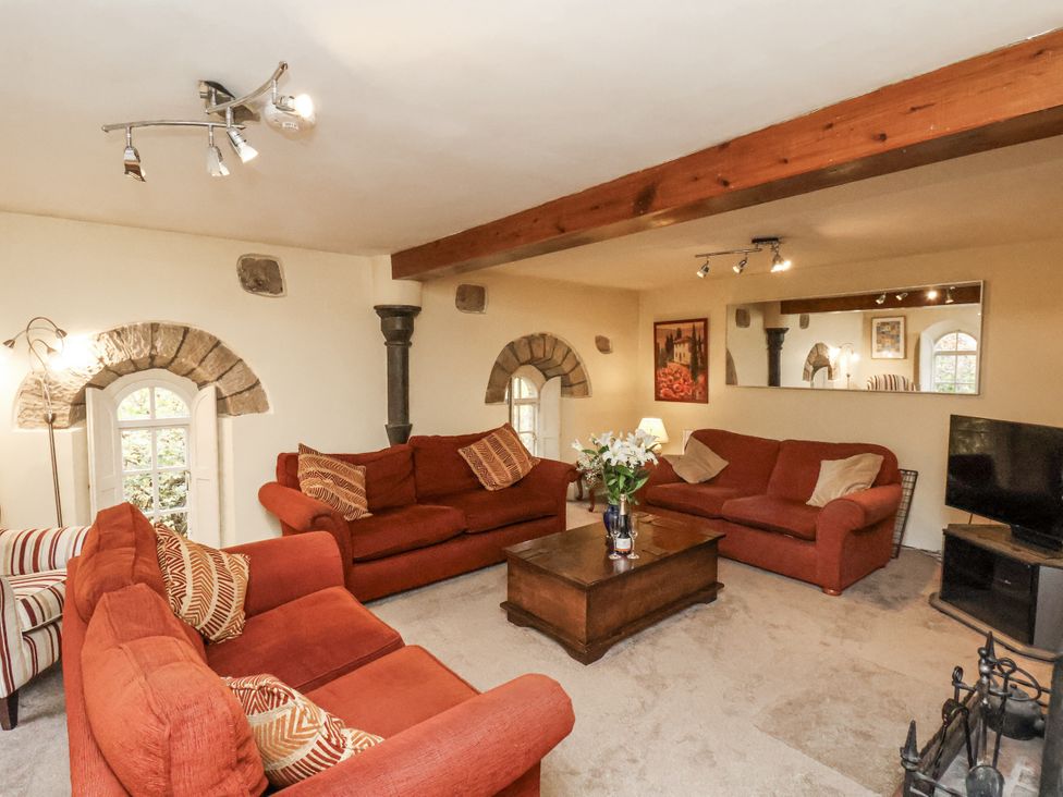 A living room with sofas and a television at 1 The Old Methodist Chapel Rosedale Abbey
