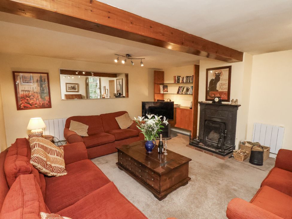 A living room with a sofa, television, and coffee table at 1 The Old Methodist Chapel, Rosedale Abbey