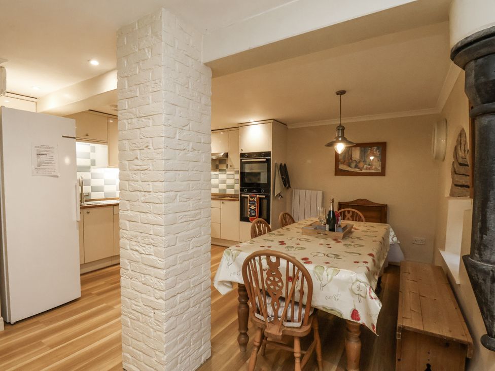 A kitchen with a dining table and chairs at 1 The Old Methodist Chapel Rosedale Abbey