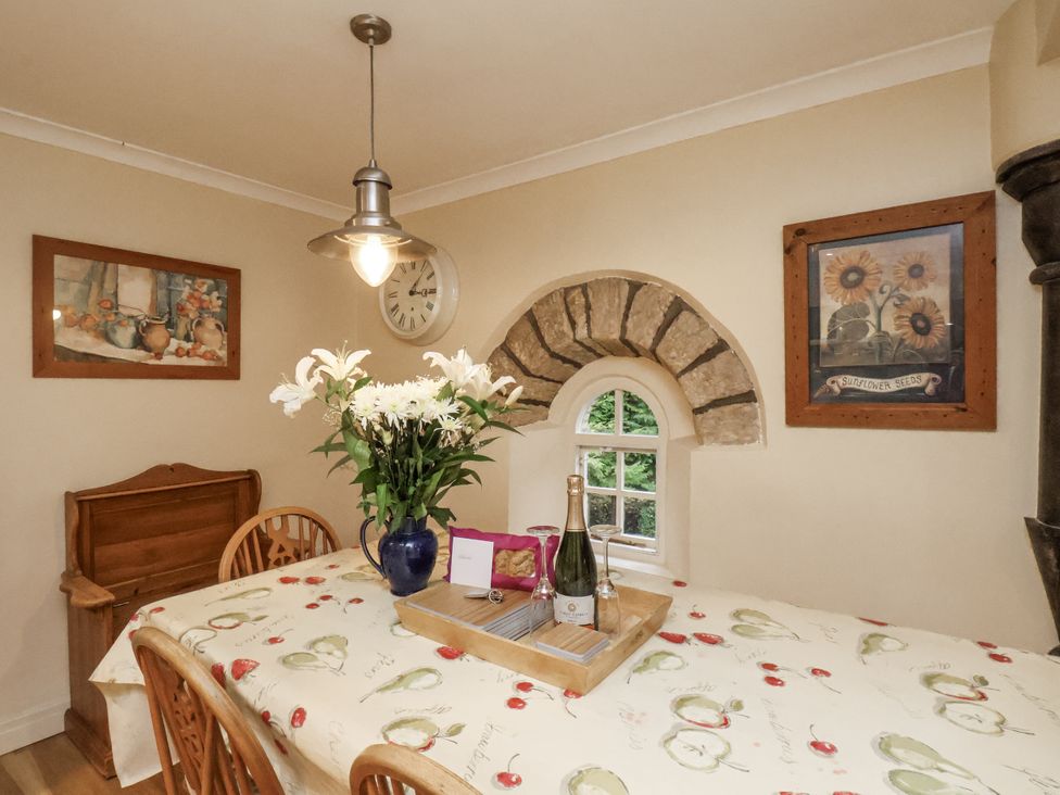 A dining room with a table, chairs, and decorations at 1 The Old Methodist Chapel Rosedale Abbey