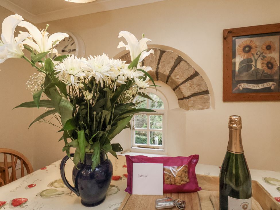 A kitchen with flowers and champagne at 1 The Old Methodist Chapel Rosedale Abbey