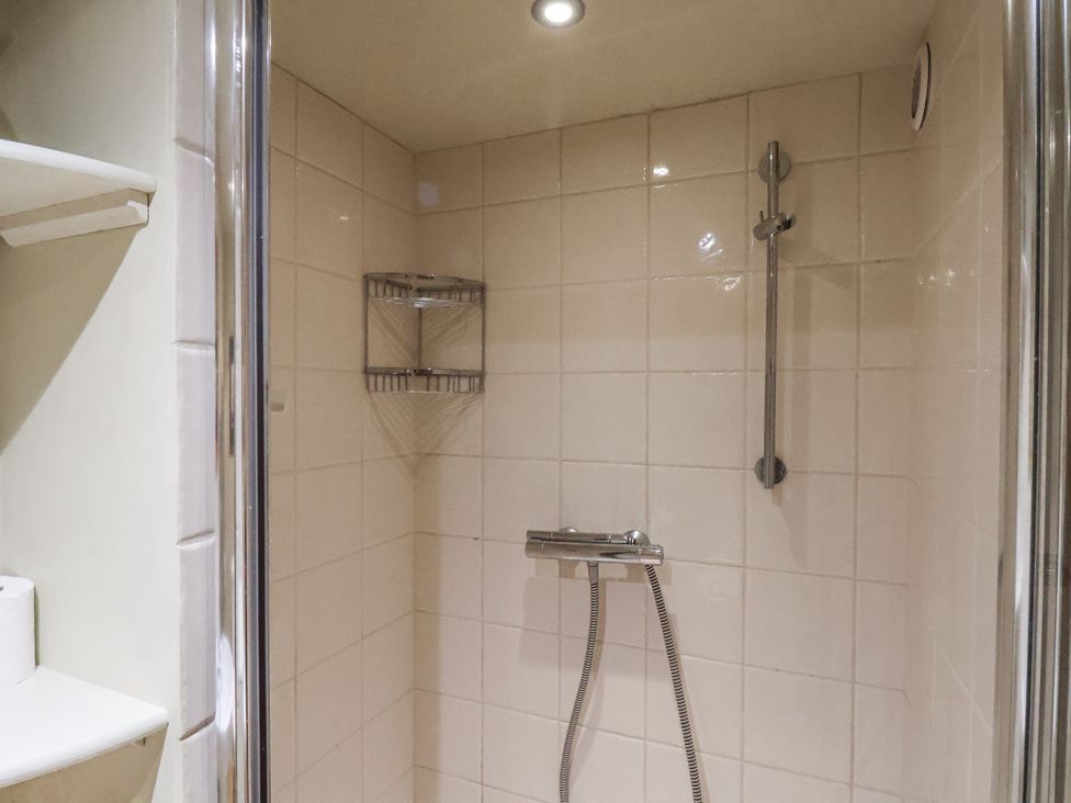 A shower with glass door and towel shelf at 1 The Old Methodist Chapel Rosedale Abbey