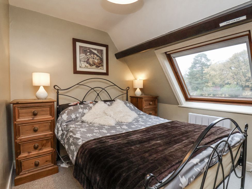 A bedroom with a bed and bedside tables at 1 The Old Methodist Chapel Rosedale Abbey