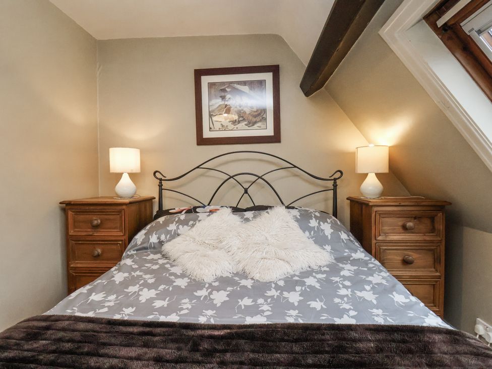 A bedroom with a bed and lamps on nightstands at 1 The Old Methodist Chapel in Rosedale Abbey