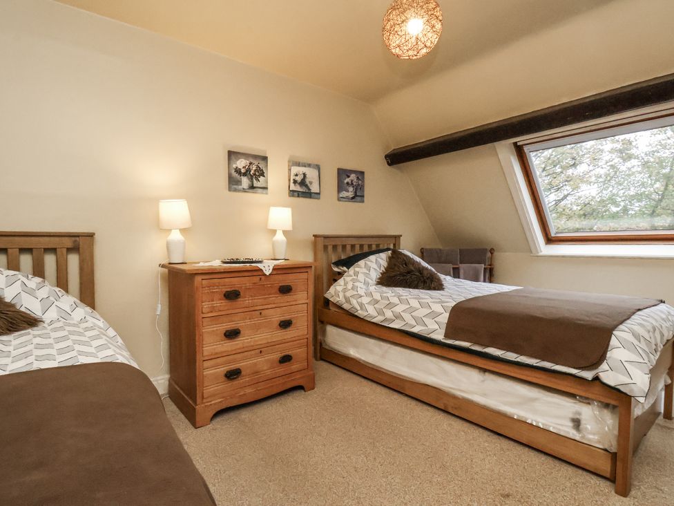 A bedroom with two beds and a dresser at 1 The Old Methodist Chapel Rosedale Abbey