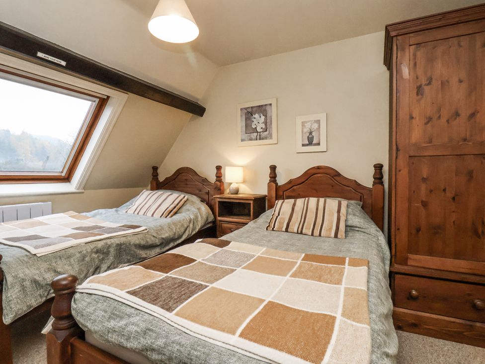 A bedroom with two beds and a window at 1 The Old Methodist Chapel Rosedale Abbey