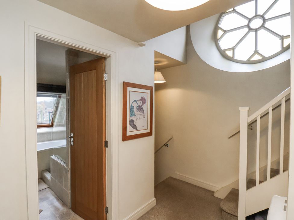 A hallway with stairs and door leading to a bathroom at 1 The Old Methodist Chapel Rosedale Abbey