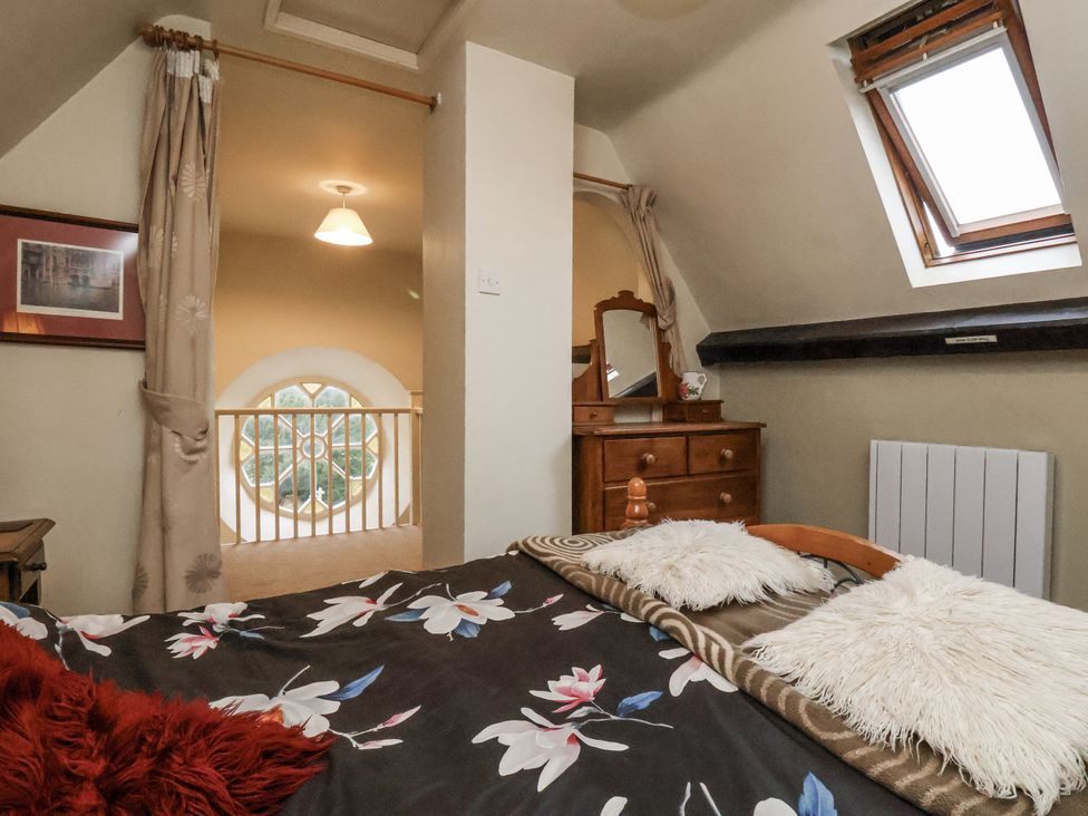A bedroom with a bed and dresser at 1 The Old Methodist Chapel Rosedale Abbey