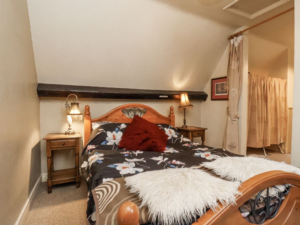 A bedroom with a bed and side table at 1 The Old Methodist Chapel Rosedale Abbey