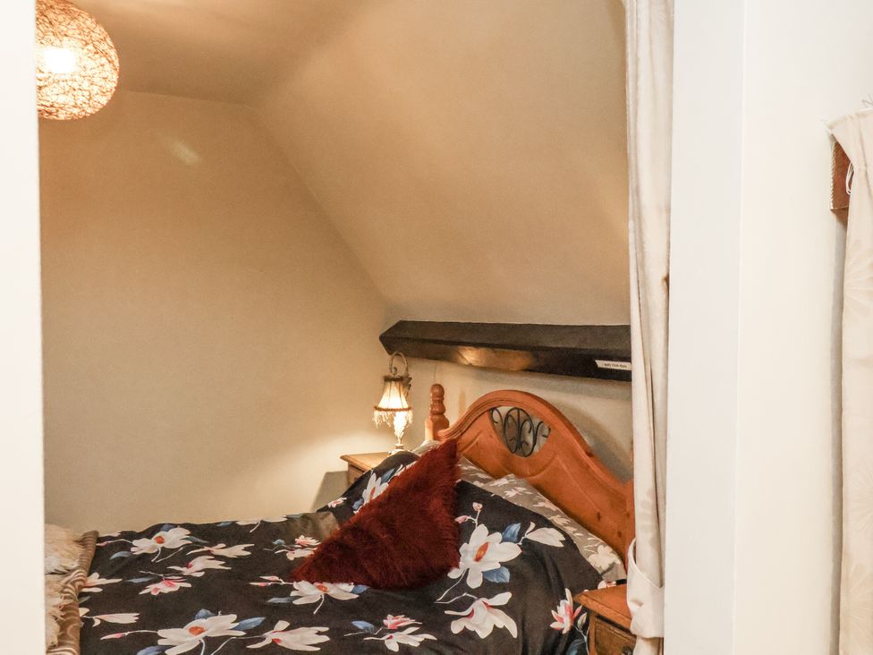 A bedroom with a bed and lamp at 1 The Old Methodist Chapel Rosedale Abbey