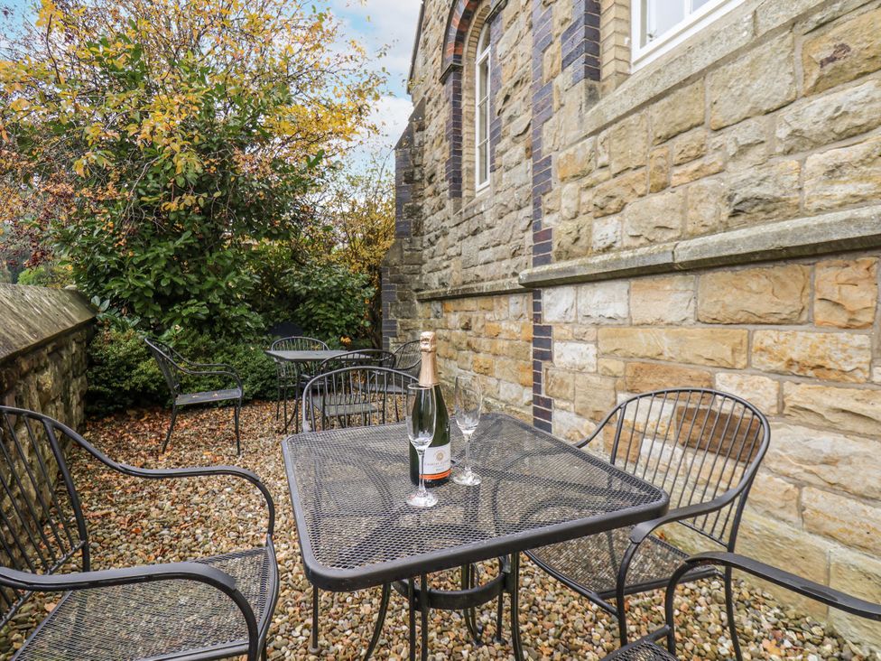 An outdoor patio with a table and chairs at 1 The Old Methodist Chapel Rosedale Abbey
