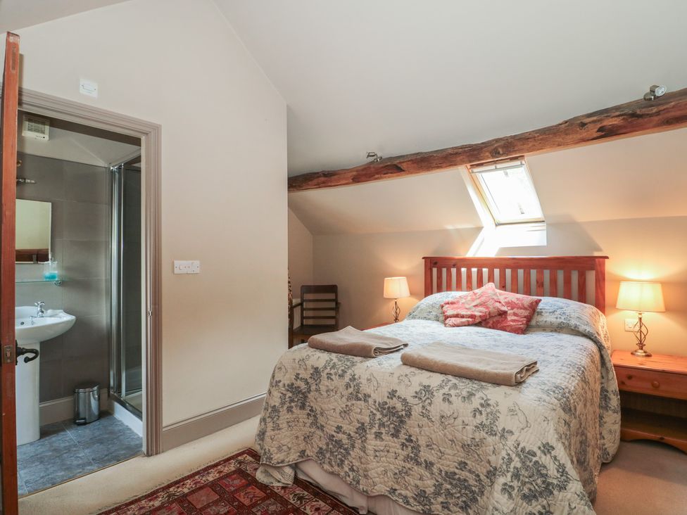 A bedroom with a bed and ensuite bathroom at The Lodge Farm Barn Deepdean near Ross-on-Wye