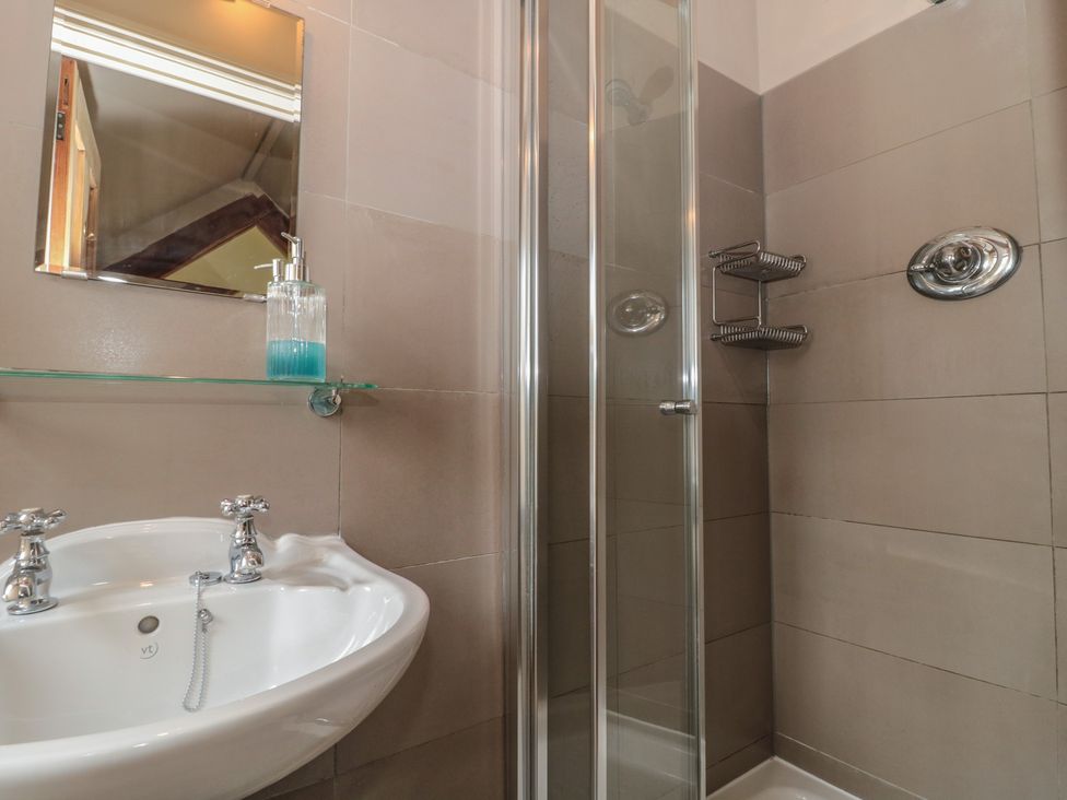 A bathroom with a sink and shower at The Lodge Farm Barn in Deepdean near Ross-on-Wye