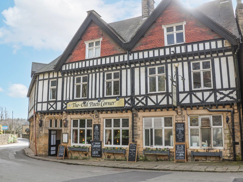 A building with signs and windows at The Old Poets Corner in 