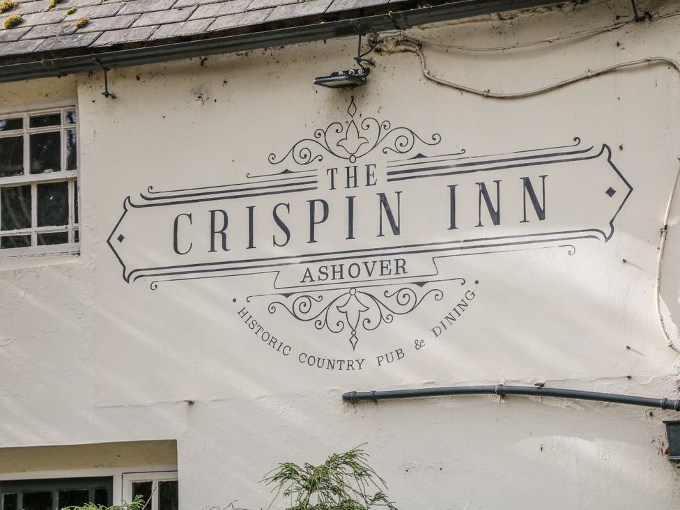 The Crispin Inn sign on a wall at The Crispin Inn in Ashover