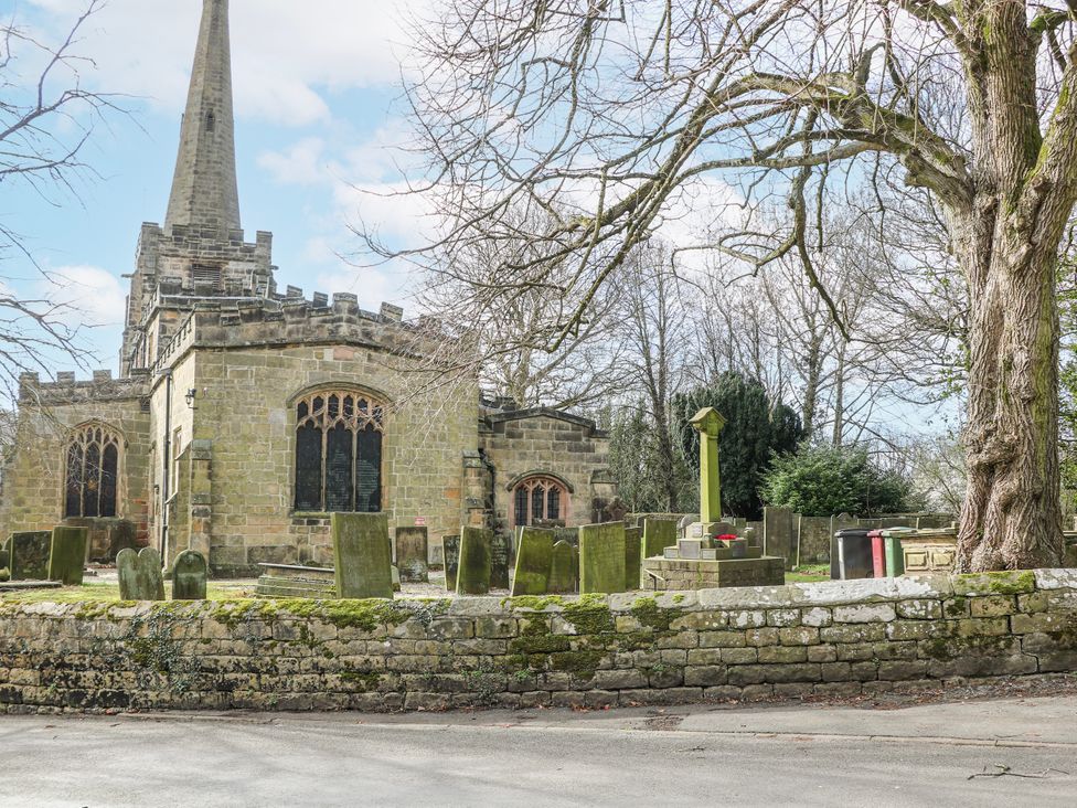 A church with a graveyard and tombstones at Little Mill 