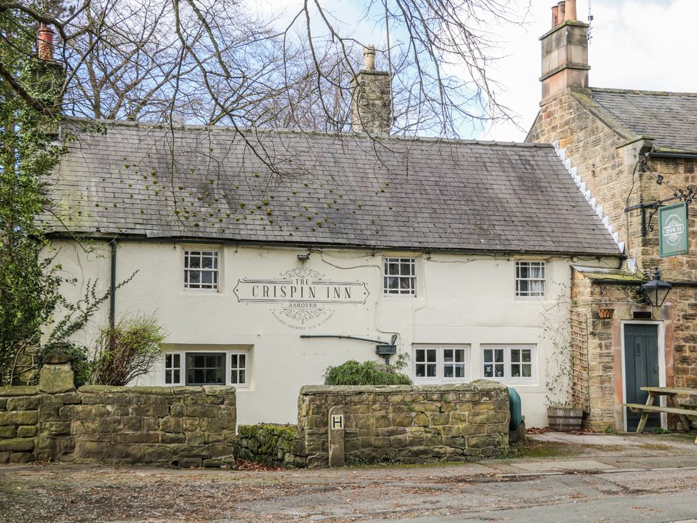 A building exterior with a sign at The Crispin Inn in Ashover