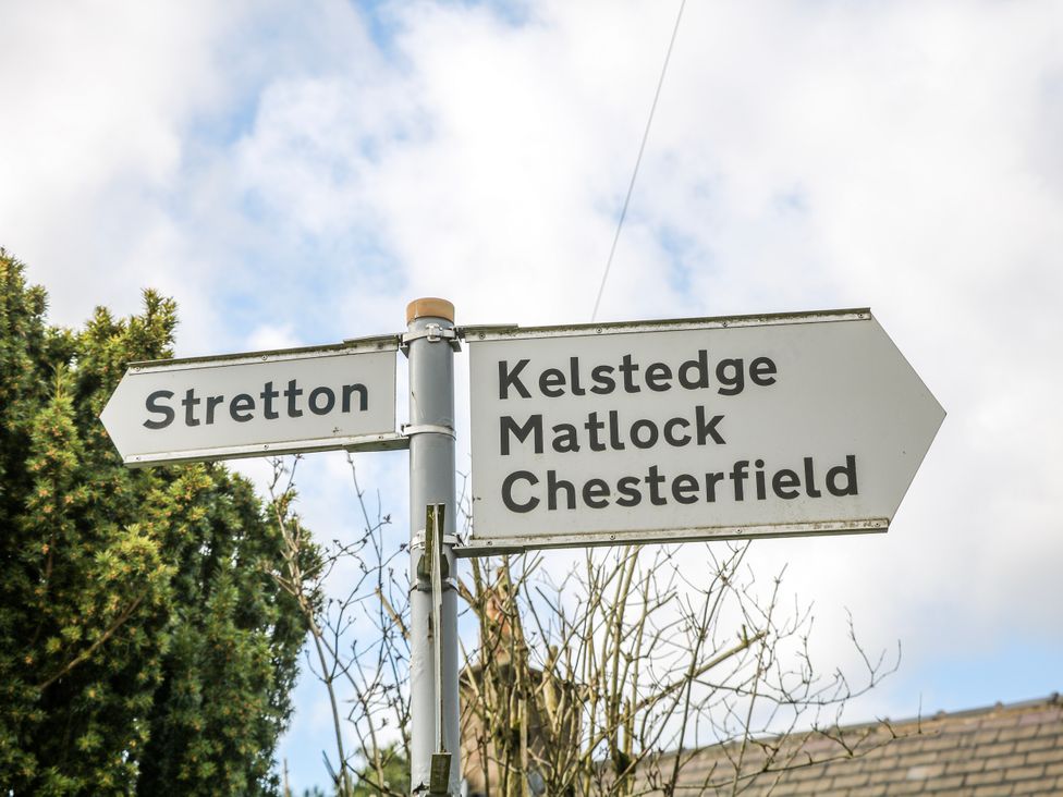 A signpost indicating directions to Stretton, Kelstedge, Matlock, and Chesterfield at Little Mill