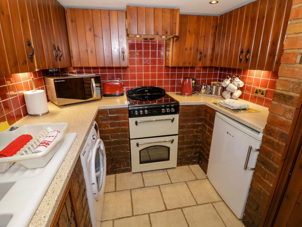 A kitchen with appliances and cabinets at Severn Bank Lodge Astley Burf near Stourport-on-Severn