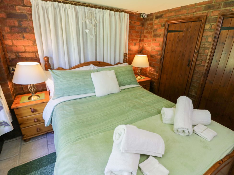 A bedroom with a bed and bedside lamp at Severn Bank Lodge Astley Burf near Stourport-on-Severn