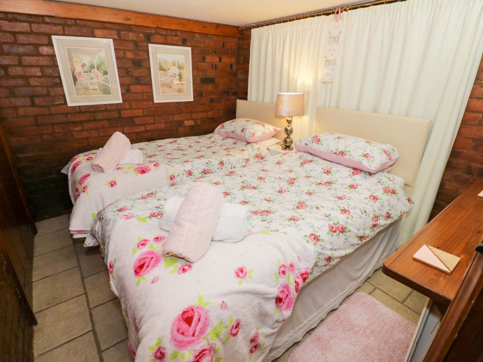 A bedroom with two beds and a lamp at Severn Bank Lodge Astley Burf near Stourport-on-Severn