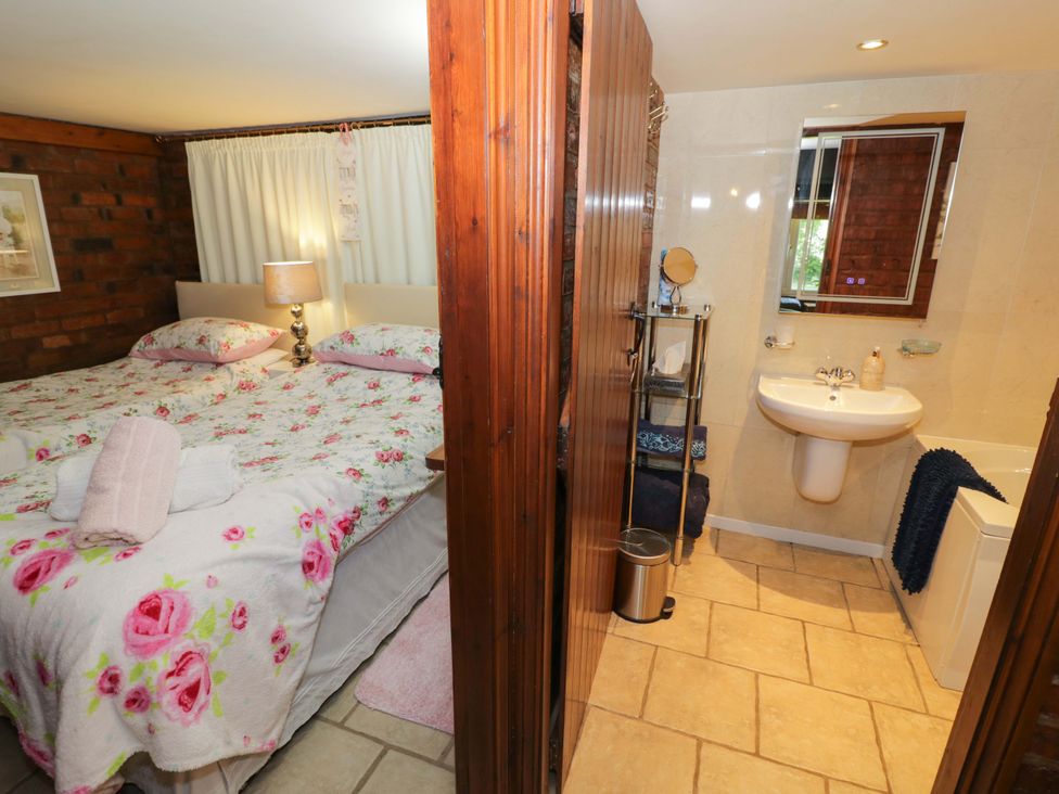 A bedroom with a bed and a bathroom area at Severn Bank Lodge Astley Burf near Stourport-on-Severn