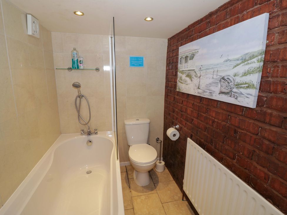 A bathroom with a bathtub and toilet at Severn Bank Lodge in Astley Burf near Stourport-on-Severn