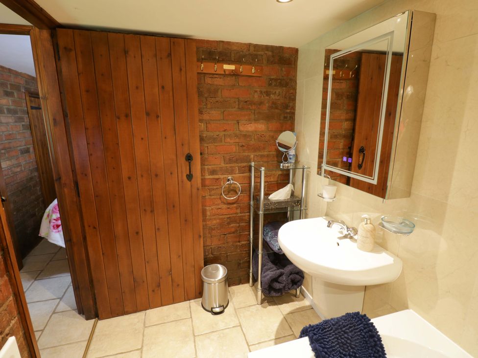 A bathroom with a sink and mirror at Severn Bank Lodge in Astley Burf near Stourport-on-Severn